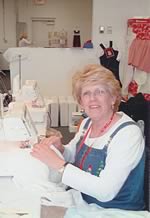 Connie Palmer demonstrating the use of the serger.